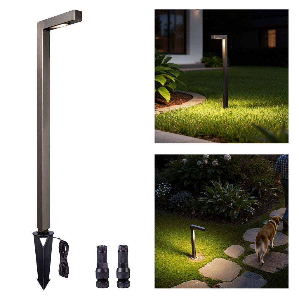 Brass path light mounted on garden and walkway, illuminating the area with warm white light.