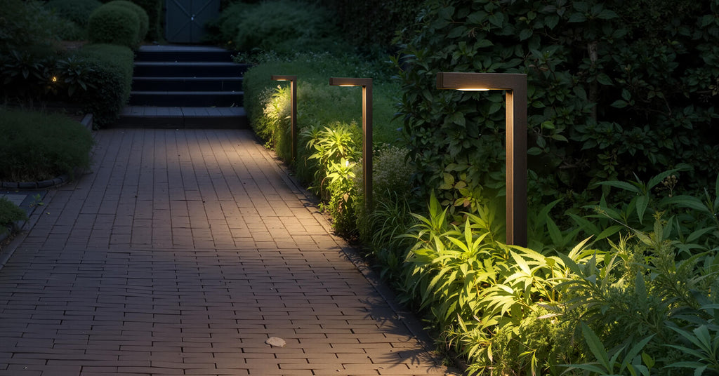 Path lights scene with L-shaped fixtures lining a garden walkway, casting downward light that improves night safety.